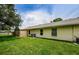 Green backyard featuring a privacy fence and mature landscaping at 1902 Elaine Dr, Clearwater, FL 33760