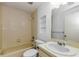 Clean bathroom with tub, tiled walls, updated toilet, and sink at 1902 Elaine Dr, Clearwater, FL 33760