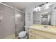 Bathroom features a walk-in shower, vanity, and new lighting fixture at 1902 Elaine Dr, Clearwater, FL 33760