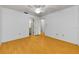 Spacious bedroom with hardwood floors and a ceiling fan with light fixture at 1902 Elaine Dr, Clearwater, FL 33760