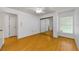 Bright bedroom with wood floors, closet and large window at 1902 Elaine Dr, Clearwater, FL 33760