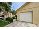 Charming home with a white garage door and mature landscaping at 1902 Elaine Dr, Clearwater, FL 33760