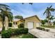 Charming single-Gathering home with a two-car garage and tropical landscaping at 1902 Elaine Dr, Clearwater, FL 33760