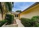 Charming single story home featuring beautiful landscaping and inviting walkway to the front door at 1902 Elaine Dr, Clearwater, FL 33760