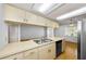 An open-concept kitchen features stainless appliances, and hardwood floors at 1902 Elaine Dr, Clearwater, FL 33760