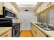 Functional kitchen featuring stainless steel appliances and wood flooring at 1902 Elaine Dr, Clearwater, FL 33760