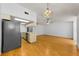 Open floor plan featuring hardwood floors and kitchen with stainless steel appliances at 1902 Elaine Dr, Clearwater, FL 33760