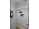 Laundry room includes storage shelf and a fire extinguisher at 1902 Elaine Dr, Clearwater, FL 33760