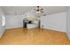 Bright, open living space featuring hardwood flooring, a ceiling fan, and adjoining kitchen at 1902 Elaine Dr, Clearwater, FL 33760