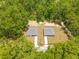 Aerial view of matching homes surrounded by tall green trees at 19275 Wildwood Dr, Brooksville, FL 34601
