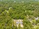 Captured above, property boasts two houses amidst a dense canopy of trees and foliage at 19275 Wildwood Dr, Brooksville, FL 34601
