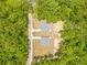 Aerial view of two homes with wooded lot, driveways, and walking path at 19275 Wildwood Dr, Brooksville, FL 34601