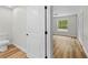 Bedroom with view of closet and large window overlooking a wooded area at 19275 Wildwood Dr, Brooksville, FL 34601