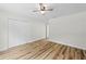 Bedroom featuring wood-look flooring, a ceiling fan, closet and neutral paint color at 19275 Wildwood Dr, Brooksville, FL 34601