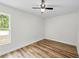 Bright bedroom with hardwood style floors and window views at 19275 Wildwood Dr, Brooksville, FL 34601