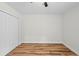 Bedroom with hardwood style floors featuring a closet with natural light at 19275 Wildwood Dr, Brooksville, FL 34601