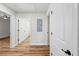 Hallway with wood-look flooring and white doors at 19275 Wildwood Dr, Brooksville, FL 34601
