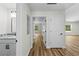 Hallway with white doors leading to various rooms, showcasing the home's layout at 19275 Wildwood Dr, Brooksville, FL 34601