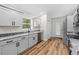 Modern kitchen featuring granite countertops, stainless steel appliances, and wood flooring at 19275 Wildwood Dr, Brooksville, FL 34601