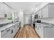 Bright kitchen featuring granite counters, modern appliances, and sleek cabinets at 19275 Wildwood Dr, Brooksville, FL 34601
