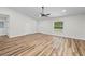 Spacious living room features wood-look flooring, neutral paint, and a modern ceiling fan at 19275 Wildwood Dr, Brooksville, FL 34601