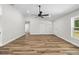 Open living area with wood floors, white trim, and natural light at 19275 Wildwood Dr, Brooksville, FL 34601