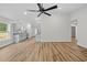 Living area featuring wood floors, a ceiling fan, and bright, neutral paint scheme at 19275 Wildwood Dr, Brooksville, FL 34601