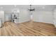 Spacious living area leading to a kitchen, featuring new flooring and modern finishes at 19275 Wildwood Dr, Brooksville, FL 34601