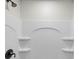 Modern shower with built-in shelving and sleek fixtures at 19275 Wildwood Dr, Brooksville, FL 34601