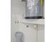 Utility closet with water heater, electrical outlet, and utility bucket at 19275 Wildwood Dr, Brooksville, FL 34601