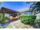 Relaxing backyard featuring a covered patio with a hammock and lush landscaping at 19555 Timberbluff Dr, Land O Lakes, FL 34638