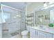 Bright bathroom with large shower, safety bars, modern vanity, and beautiful neutral toned wall and floor tiles at 19555 Timberbluff Dr, Land O Lakes, FL 34638