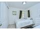 Bright bedroom with an airy feel features carpet, closet, windows, and an accent painting at 19555 Timberbluff Dr, Land O Lakes, FL 34638