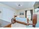 Cozy bedroom with tile floors, neutral-toned walls, a window with blinds, and dark wooden furniture at 19555 Timberbluff Dr, Land O Lakes, FL 34638