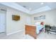 Bright bedroom with tiled floors, tray ceiling, and a mounted television at 19555 Timberbluff Dr, Land O Lakes, FL 34638