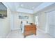 Cozy bedroom featuring a tray ceiling, tiled floors, and natural light at 19555 Timberbluff Dr, Land O Lakes, FL 34638