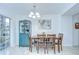 Bright dining area featuring stylish furnishings, tile floors, and sliding glass doors to the lanai at 19555 Timberbluff Dr, Land O Lakes, FL 34638