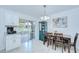 Bright dining area featuring tile floors, sliding glass doors to the lanai, and stylish furnishings at 19555 Timberbluff Dr, Land O Lakes, FL 34638