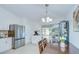Bright dining area with white cabinets, stainless steel appliances, and sliding glass doors to the patio at 19555 Timberbluff Dr, Land O Lakes, FL 34638