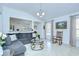 Spacious living room with tile floors, a rocking chair, and open access to the kitchen at 19555 Timberbluff Dr, Land O Lakes, FL 34638