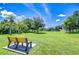 Lush park featuring an expansive green lawn, mature trees, and blue skies at 19555 Timberbluff Dr, Land O Lakes, FL 34638