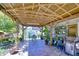 Spacious covered patio with exposed beam and brick flooring, ideal for outdoor entertainment at 19555 Timberbluff Dr, Land O Lakes, FL 34638