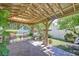 Relaxing covered patio with exposed beams, lush greenery, and brick pavers at 19555 Timberbluff Dr, Land O Lakes, FL 34638