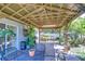 Under the gazebo, an outdoor patio with brick floor, patio set, and backyard with greenery at 19555 Timberbluff Dr, Land O Lakes, FL 34638