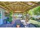Charming covered patio area with brick flooring, perfect for outdoor dining and relaxation at 19555 Timberbluff Dr, Land O Lakes, FL 34638