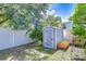 Well-maintained storage shed in a fenced backyard with surrounding landscaping at 19555 Timberbluff Dr, Land O Lakes, FL 34638
