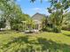 Spacious backyard featuring a pergola and mature, tropical landscaping at 2068 Diane Ave, Palm Harbor, FL 34683