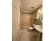 Cozy bathroom with vintage tile floors, a pedestal sink, and a shower-tub combination with a decorative shelf at 2068 Diane Ave, Palm Harbor, FL 34683