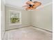 Bedroom featuring a ceiling fan and a view of the neighborhood through a window at 2068 Diane Ave, Palm Harbor, FL 34683