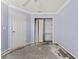 Bedroom with open closet and damaged flooring at 2068 Diane Ave, Palm Harbor, FL 34683